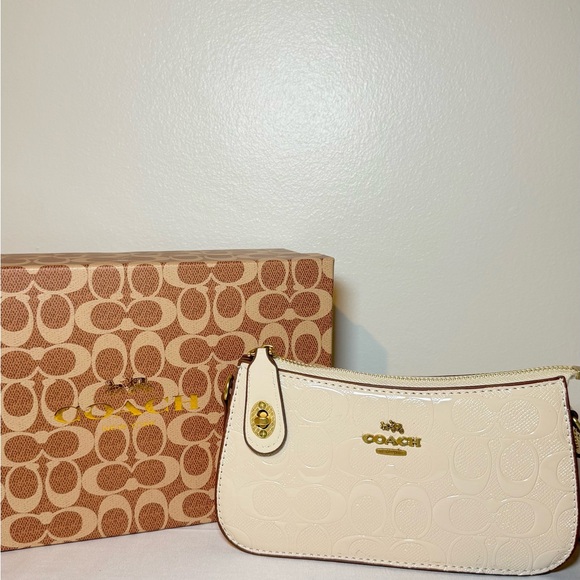Coach Handbags - Coach Ivory Wristlet with Gold Details
